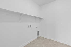 Washroom with hookup for a washing machine and hookup for an electric dryer