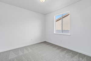 Carpeted empty room with baseboards