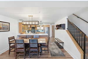 Dining area featuring light wood finished floors and stairway