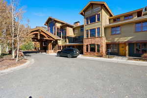 View of front of house featuring stone siding and driveway