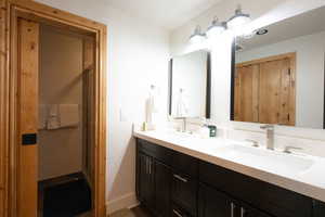 Bathroom with double vanity and a shower stall