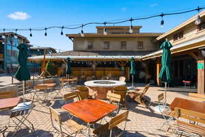 View of patio / terrace featuring outdoor dining space and an outdoor fire pit