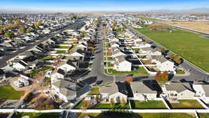 Aerial view of property and surrounding area with nearby suburban area