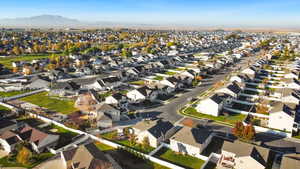 Aerial view of property's location featuring nearby suburban area and mountains