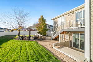 Fenced backyard with a patio area and stairs
