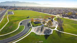 Aerial view of property's location featuring mountains and nearby park in suburban area,