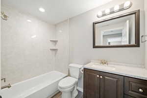 Bathroom with vanity, shower / tub combination, and recessed lighting