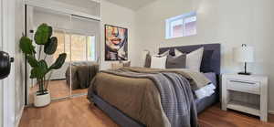 Bedroom featuring wood finished floors and a closet
