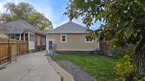 View of home's exterior with stucco siding and a cooling unit