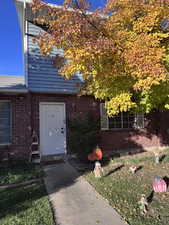 View of exterior entry featuring brick siding