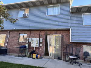 Rear view of house featuring a patio area and brick siding