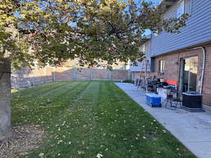 Fenced backyard with a patio