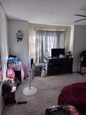 Bedroom featuring a textured ceiling and carpet