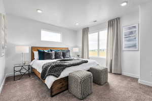 Carpeted bedroom with multiple windows and recessed lighting
