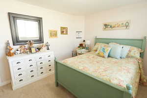 Bedroom with light colored carpet