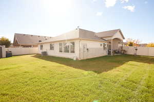 Rear view of house with a fenced backyard, a patio area, stucco siding, and roof with shingles