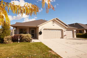 Ranch-style house featuring brick siding, concrete driveway, a front lawn, a garage, and roof with shingles