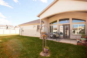 Back of property with brick siding, a patio, and roof with shingles