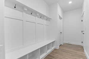 Mudroom featuring light wood-style flooring and recessed lighting