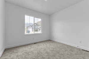Bedroom 2 featuring light colored carpet and a mountain view
