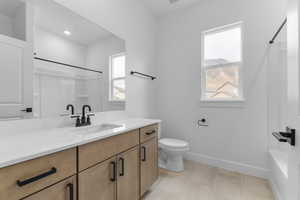 Bathroom with vanity, light tile patterned floors, and shower / tub combo with curtain