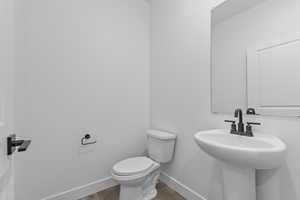 Bathroom with wood finished floors and baseboards