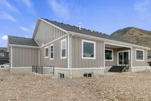 Back of house featuring a covered patio and basement entrance