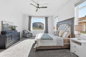 Carpeted bedroom featuring a mountain view, ceiling fan, and recessed lighting