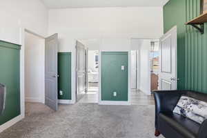 Office/bedroom with light carpet and baseboards