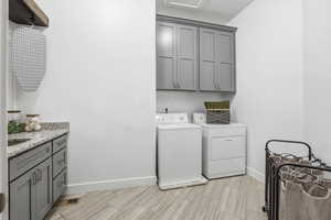 Laundry room with cabinet ample space,  washing machine, clothes dryer, and tile floor