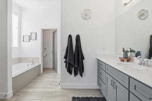 Bathroom with vanity and a garden tub