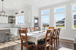 Dining room featuring dark wood finished floors, recessed lighting, and a mountain view