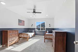 Bedroom with light colored carpet, a ceiling fan, recessed lighting, and a mountain view