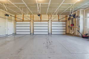 3-car garage featuring a garage door openers