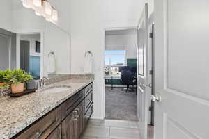 Ensuite jack-and-jill bathroom featuring vanity and tile floor