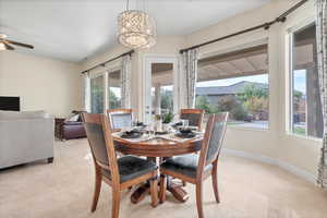 Dining space with a ceiling fan and light tile patterned floors