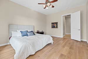 Bedroom with light wood-style flooring and a ceiling fan