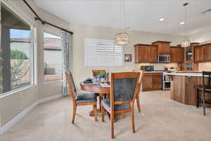 Dining space with recessed lighting, a chandelier, and light tile patterned floors