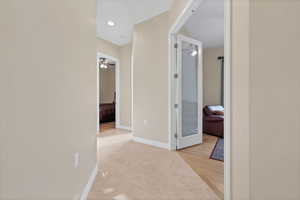 Hallway featuring light wood finished floors and recessed lighting