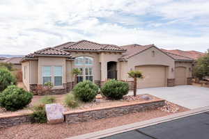 Mediterranean / spanish-style house featuring stone siding, concrete driveway, stucco siding, and an attached garage