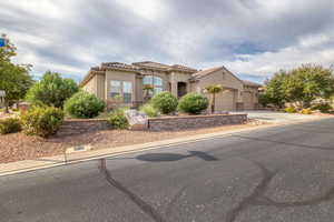 Mediterranean / spanish house featuring stucco siding, a garage, a tiled roof, and driveway