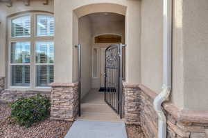 Entrance to property with stone siding and stucco siding