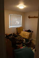 Bedroom with a textured ceiling and carpet floors