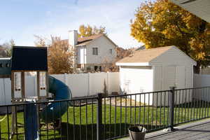 Exterior space with a storage shed and a fenced backyard
