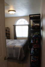 Bedroom featuring a textured ceiling and carpet