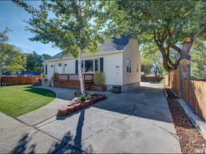 View of front of home featuring a fenced backyard, concrete driveway, and crawl space