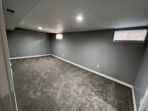 Basement with carpet and baseboards