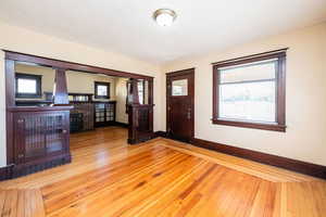 Entryway with baseboards and light wood-style floors