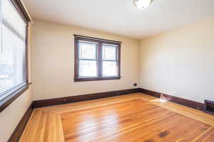 Spare room featuring hardwood / wood-style floors and baseboards