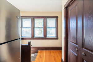 Corridor with light wood finished floors and a textured ceiling